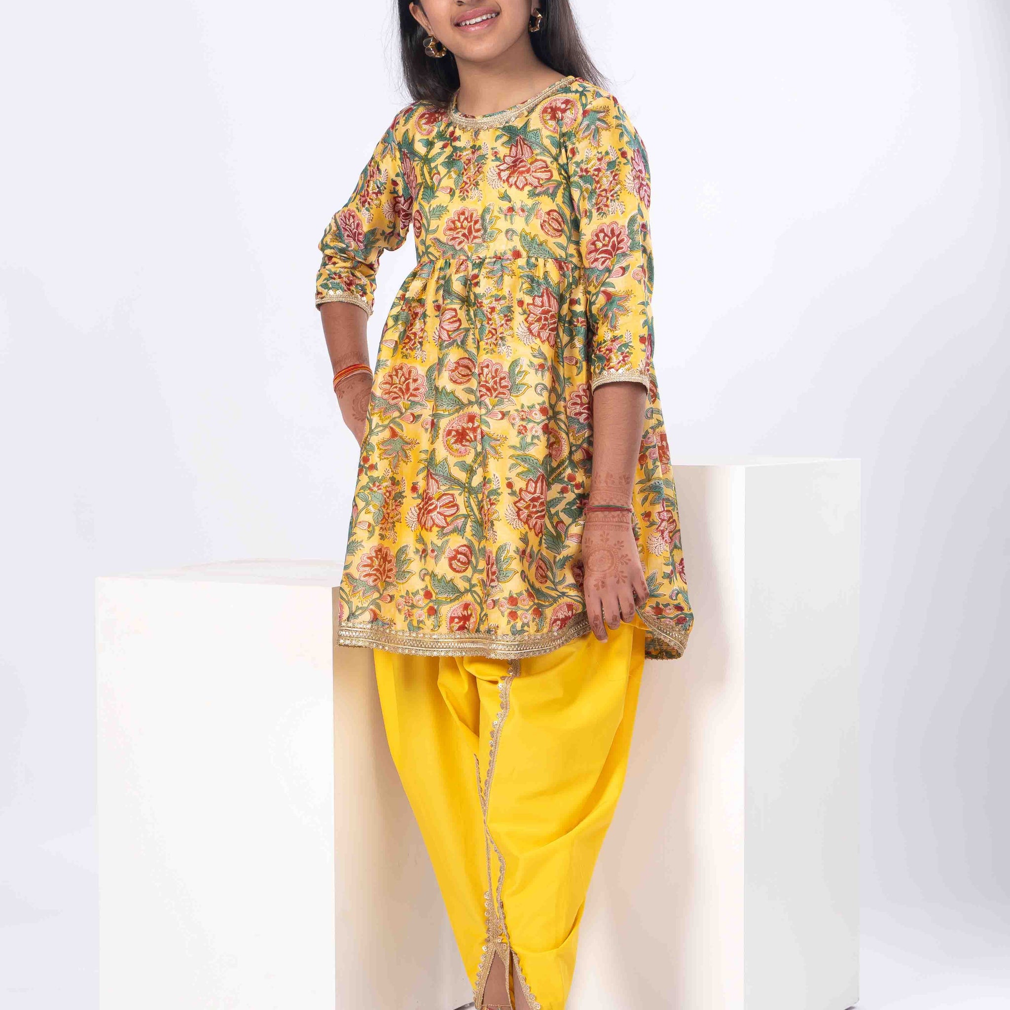 floral yellow girls kurta with yellow dhoti pants.