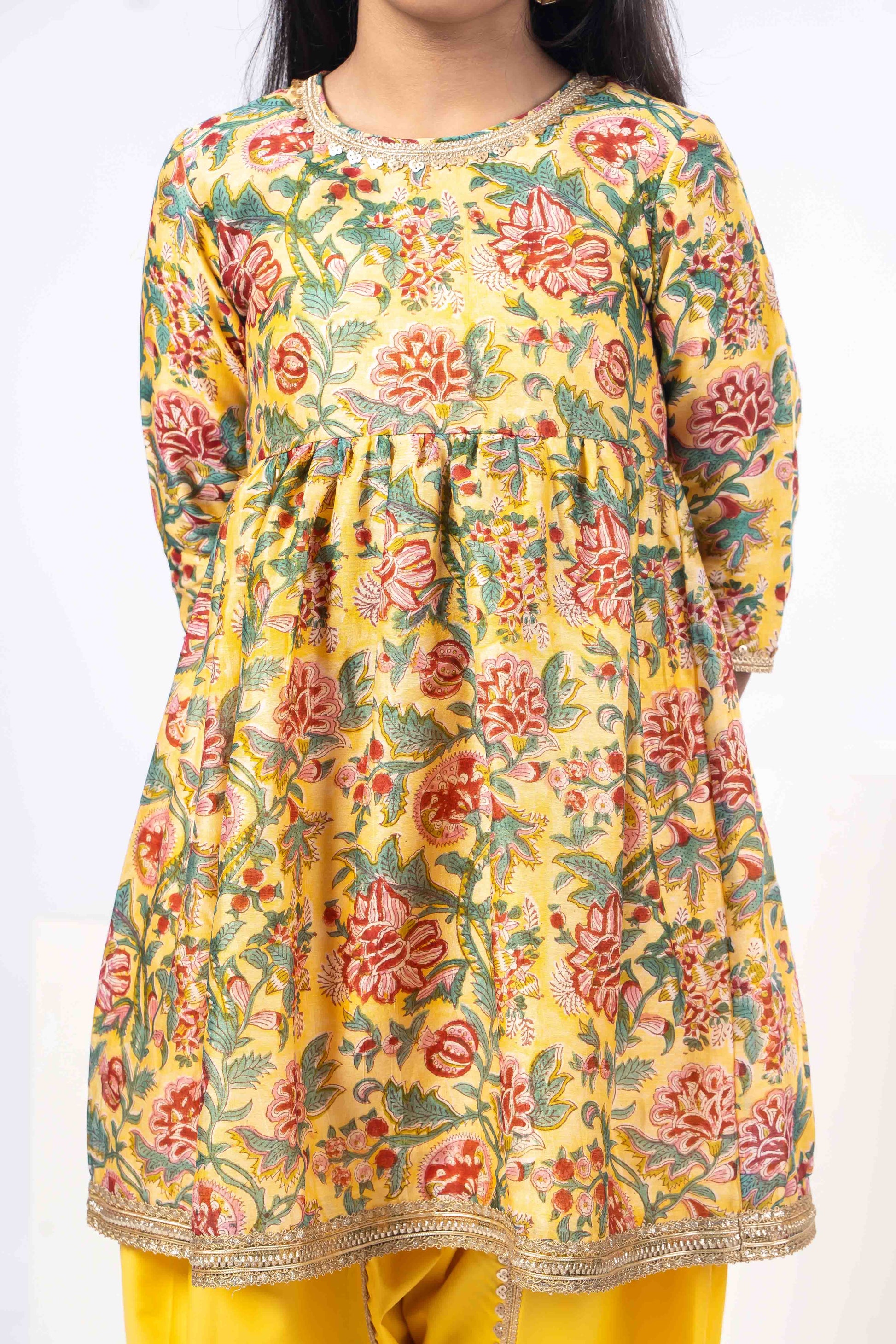 floral yellow girls kurta with yellow dhoti pants.
